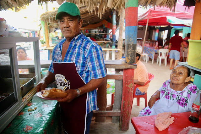 jose and alexandra make cochinita pibil, holbox,yucatan, mexico