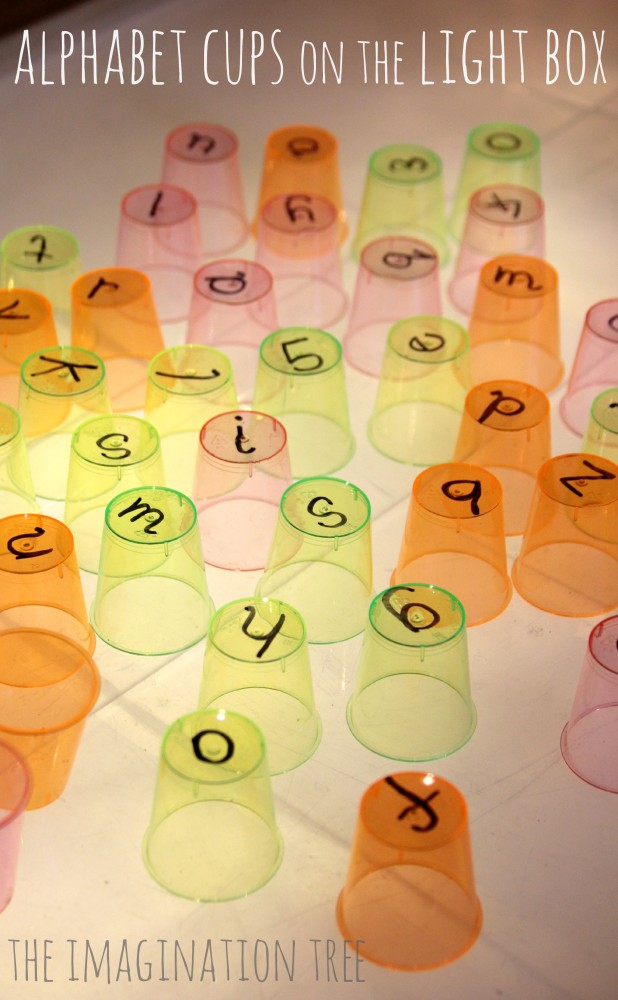 Alphabet cups on the light table from The Imagination Tree