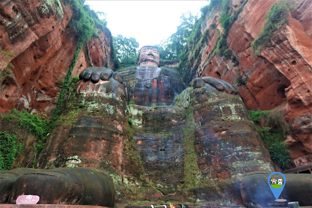 Full shot of The Leshan Giant Buddha once getting to the ground from the stairway in Sichuan province of China Full shot of The Leshan Giant Buddha once getting to the ground from the stairway in Sichuan province of China