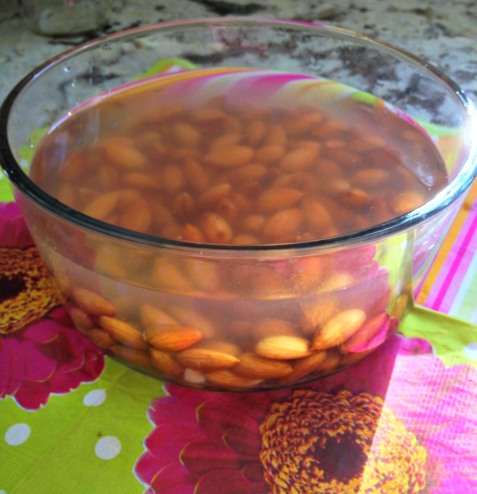 bowl of water with soaked almonds