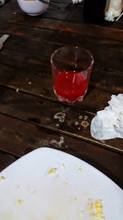 A shot glass full of snake blood and vodka, served at a restaurant in Muine, Vietnam