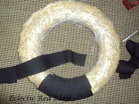 Wrap black strips around straw wreath