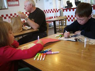 Children colouring at an airport restaurant