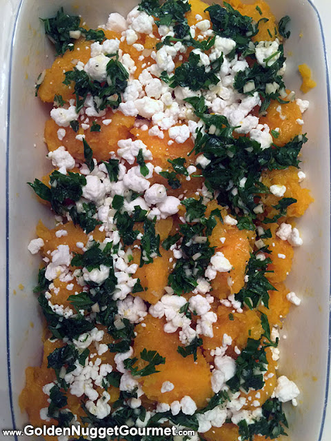Roasted Butternut Squash topped with goat cheese and herb oil in serving dish
