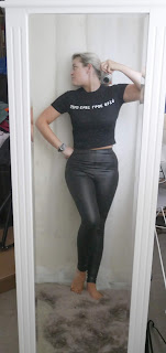 mirror selfie wearing high street fashion black crop top