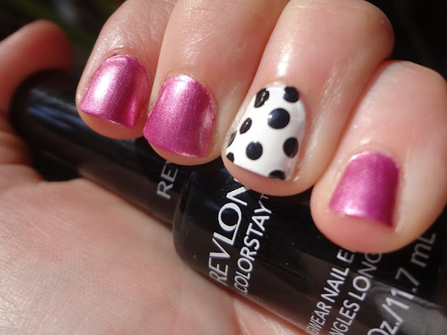 black and white polka dot accent nail with pink polish