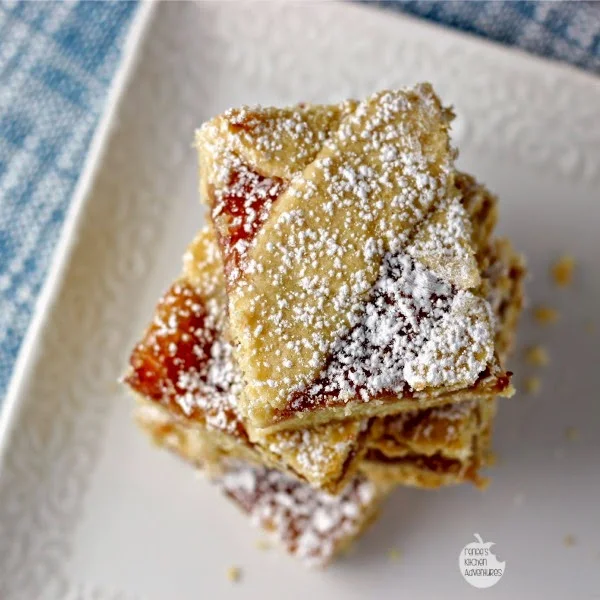 Mom's Strawberry Squares on a white plate dusted with powdered sugar