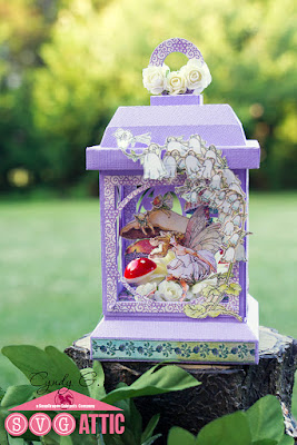 Paper lantern with fairies inside sitting on flowers