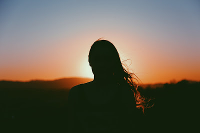 girl outlined against the sunset