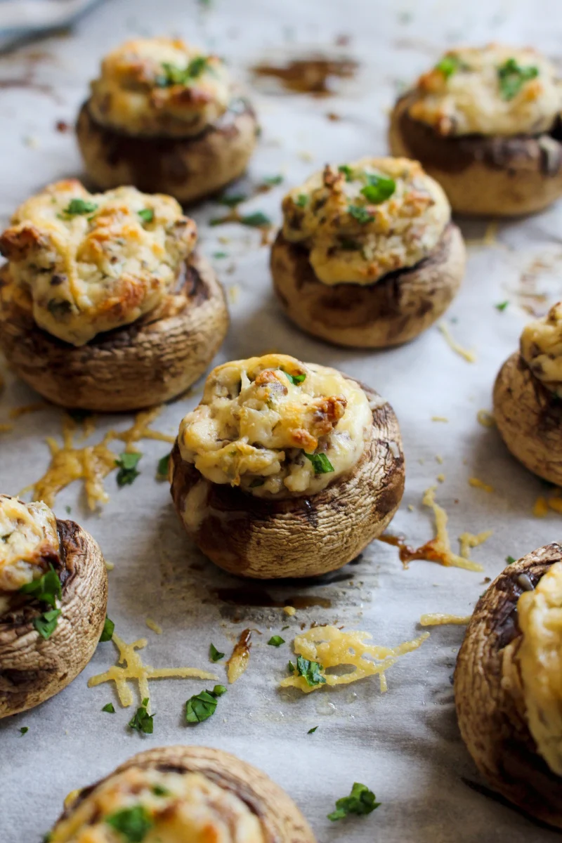 Cream Cheese Stuffed Mushrooms on a parchment-lined baking sheet.