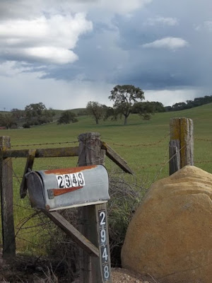 mailbox with a open field behind it