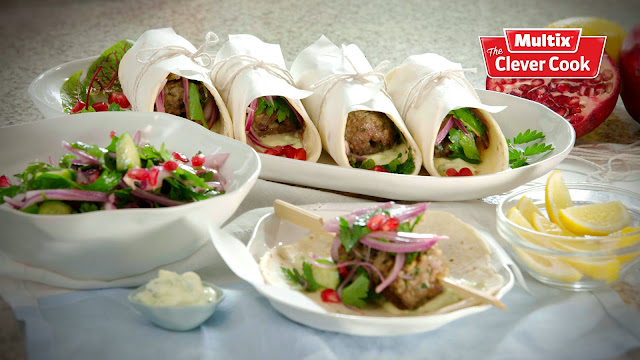 Lamb koftas with parsley mint and red onion salad in serving dishes