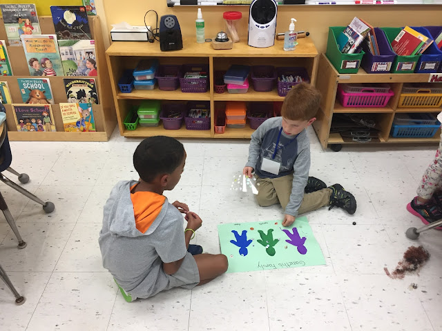 kindergartener and third grader working on family project