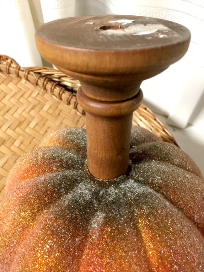wooden stand in bottom of pumpkin