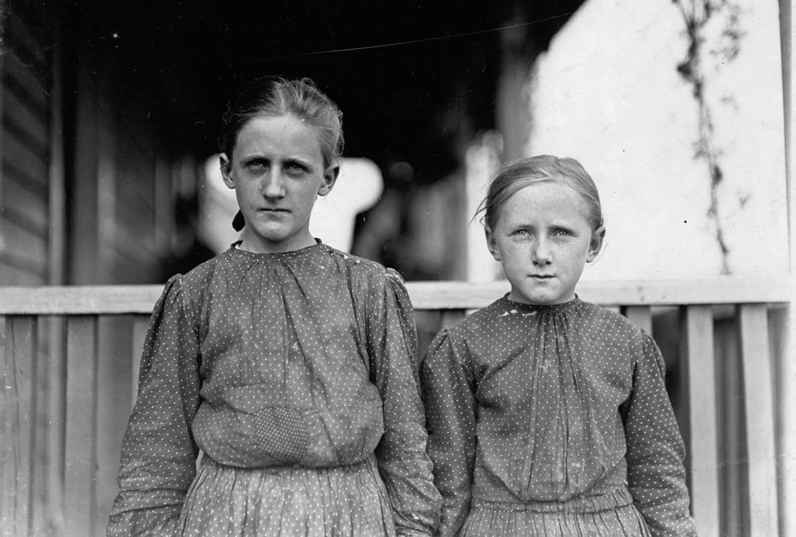 Minnie Carpenter, (left) photographed in November of 1908 at Loray Mill in Gastonia, North Carolina. Minnie makes fifty cents for a 10-hour day as a spinner in the mill. The younger girl works irregularly.