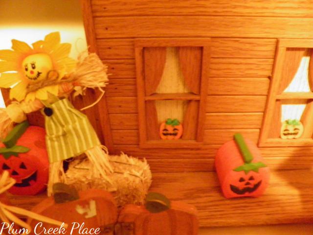 Wooden fall house, pumpkins, hay bales