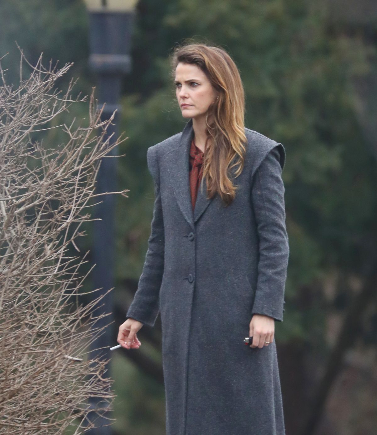 Keri Russell puffs on a cigarette as she takes a break on The Americans
