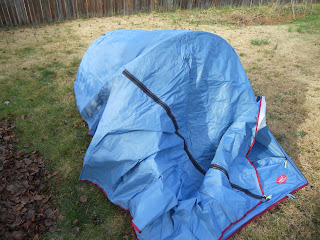 Drape the fly over the tent and stake at all tabs to secure