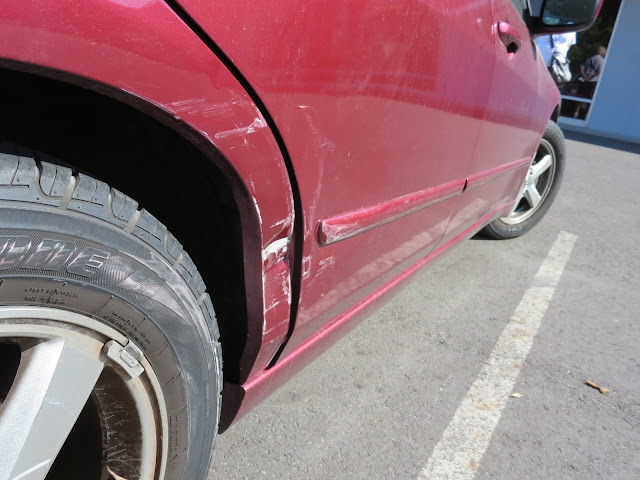 Dented door & quarter panel before repairs at Almost Everything Auto Body