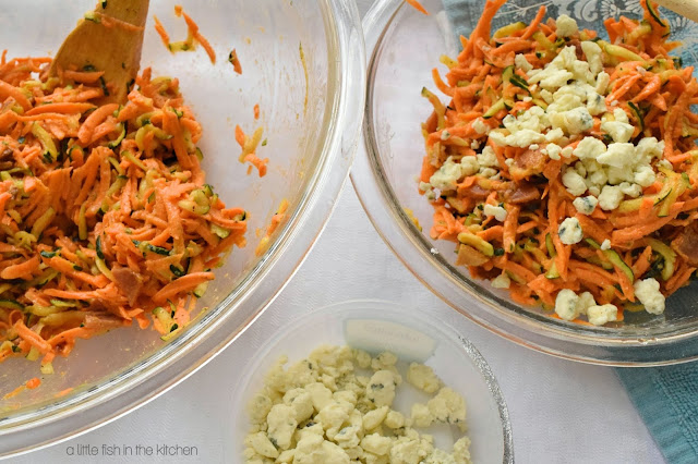 Two mixtures for the sweet potato cakes are ready to be formed. One mixing bowl contains half of the veggie mixture without gorgonzola cheese, while the other has bit of flufffy gorgonzola cheese folded in. 