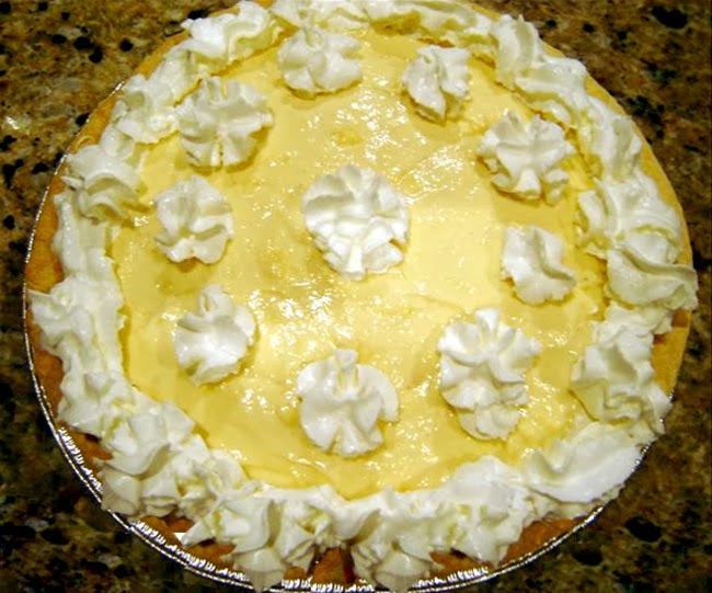 Creamy Eggnog Pie: Classic seasonal dessert of eggnog blended with whipped cream and set with gelatine in a pastry shell served decorated with piped whipped cream