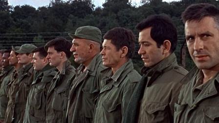 John Cassavetes looking at the camera in the lineup of condemned men from The Dirty Dozen movieloversreviews.filminspector.com