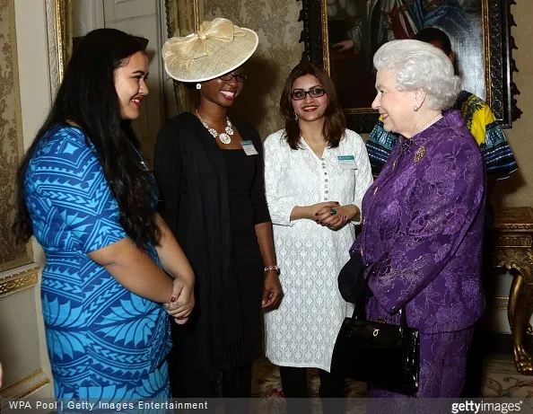 Queen Elizabeth II speaks with guests during a reception to mark Commonwealth Day at Marlborough House 