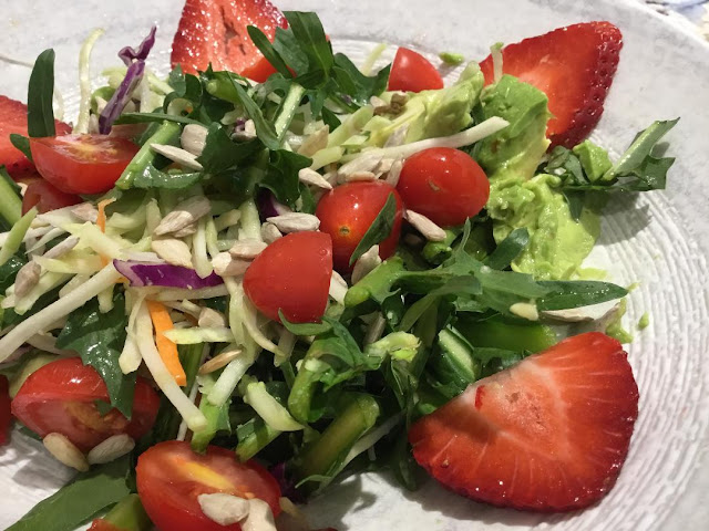 salad with strawberry slices and sunflower seeds