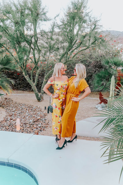 whitney and megan wearing yellow jumpsuits