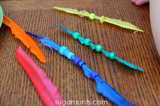 Beads and feathers for fine motor and learning Threading colored beads on feathers is a great way for prechoolers and toddlers to work on colors and fine motor skills.