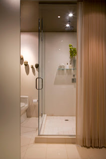 A drapery panel conceals the shower when privacy is needed.