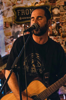 Simon Denzley playing guitar and singing with Denzeity