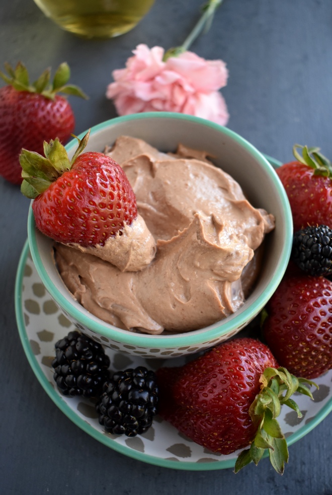 Chocolate Peanut Butter Greek Yogurt Dip is super easy to make with 4 ingredients! Pair with fruit, pretzels and more for a healthier delicious snack. www.nutritionistreviews.com