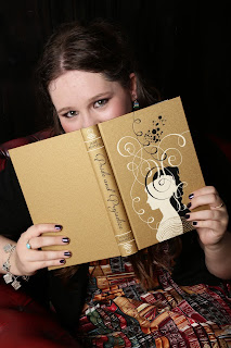 Sophie Andrews hiding behind a book