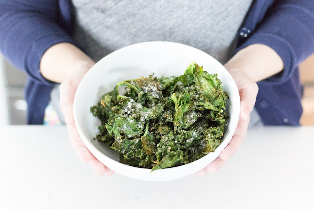 Here's the recipe you are looking for! The most perfectly easy kale chips. These oven baked kale chips are so versatile and are ready to go in 15 minutes!   kale chips, homemade chips, healthy chips, diet chips, healthy eating, flavor of life olive oil, extra virgin olive oil recipe, parmesan chips, salt and vinegar chips