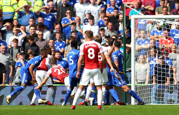Shkodran Mustafi of Arsenal (20) scores his team's first goal during the Premier League match between Cardiff City and Arsenal FC at Cardiff City Stadium on September 2, 2018 in Cardiff, United Kingdom.