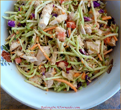 Spicy Broccoli Slaw and Chicken Salad, for lunch or for dinner on a hot summer night. Mix just a few ingredients together, refrigerate, let everyone choose their favorite toppings when you're ready to serve. | Recipe developed by www.BakingInATornado.com | #recipe #salad #chicken