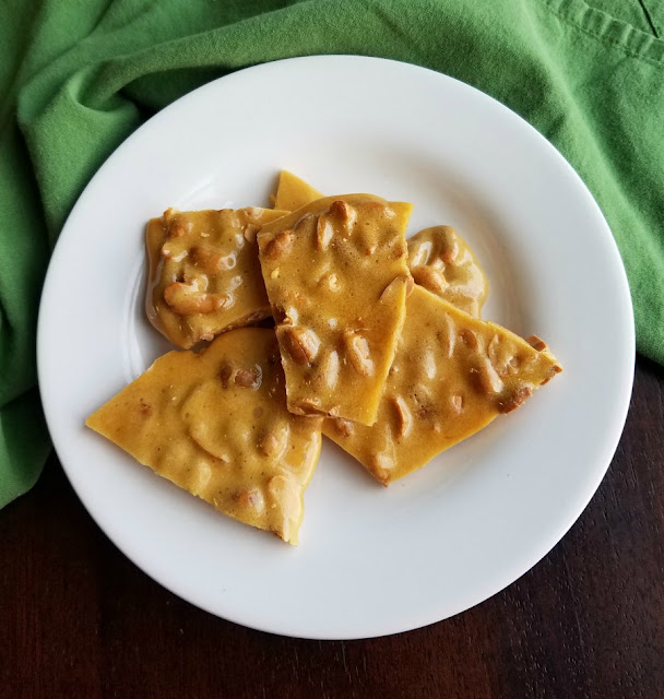 Sweet, crunchy peanut brittle is a classic candy that you can easily make at home. This updated recipe doesn't involve a candy thermometer, just a microwave. Make some asap! plate of pieces of easy microwave peanut brittle
