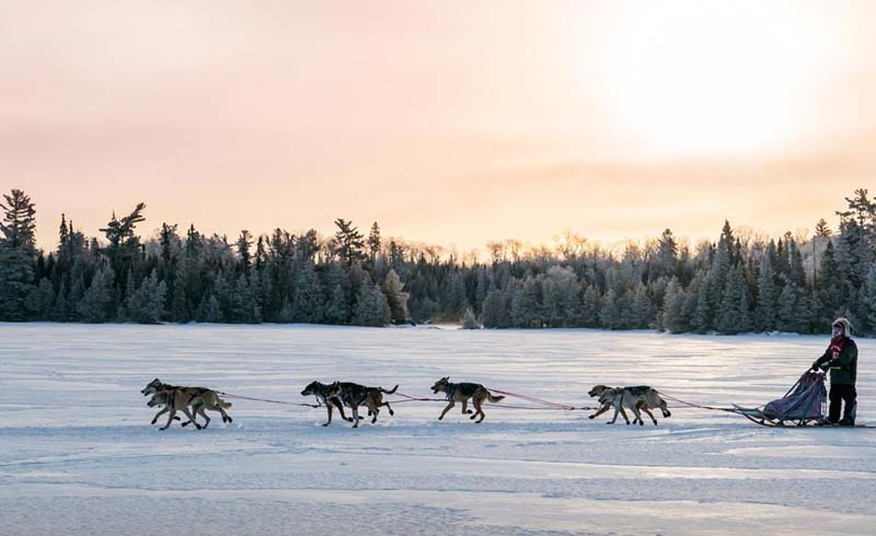 A team crosses Poplar Lake at Trail Center at sunrise.