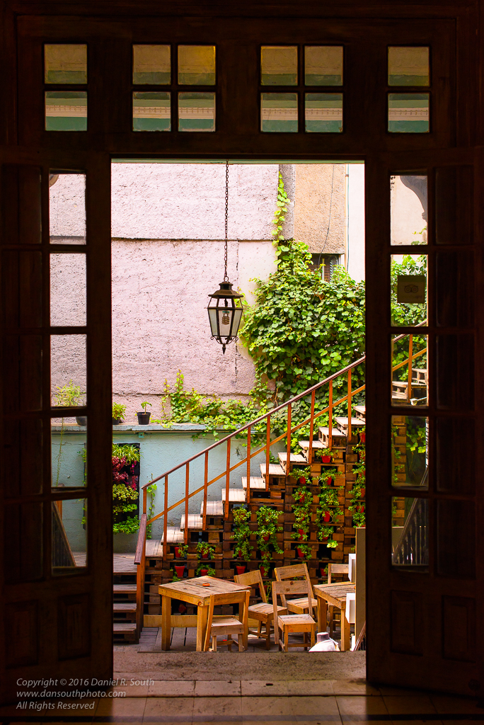 a photo of a doorway to a quiet alley way in mexico city