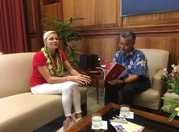 Princess Charlene of Monaco visited Honolulu, Hawaii met Governor David Idge. She wore red shirt and white pants