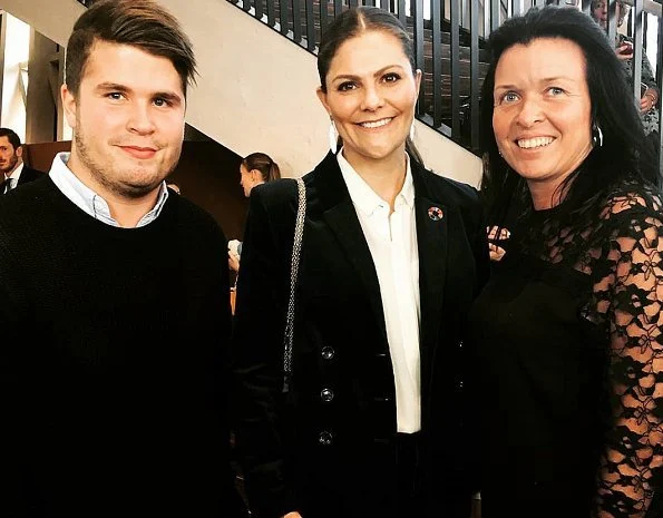 Crown Princess Victoria wore Yves Saint Laurent suede pumps, and she wore Kreuger Jewellery summer feather earrings at Karolinska Institute