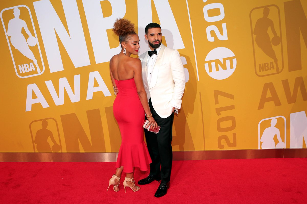 Dressed in a classic tux, Drake wrapped his arm around Ros as they posed fo...