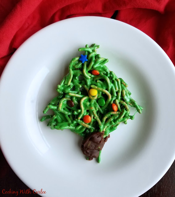 These festive cookies are a Christmasy twist on a favorite family recipe. They are no-bake and sure to put a smile on your face! no bake christmas tree cookie made from chow mein noodles and candy