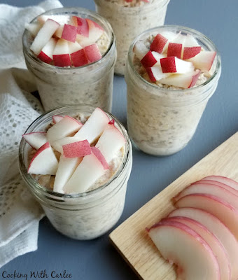 Creamy, dreamy and delicious, these overnight oats make the morning so easy. Just grab and jar and a spoon and hit the road! If you want to serve to guests, you can dress them up with a few more fresh chopped peaches, a drizzle of honey and a sprinkle of cinnamon. Either way, you'll be glad you did it! sliced white peaches next to jars of overnight oatmeal topped with fruit