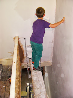 dangerous position for child painting over open staircase