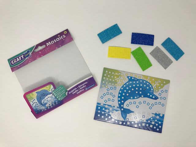 The Dolphin Mosaic out of the packaging showing the picture board and foam pieces