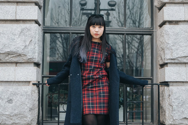 City Look with Plaid This is a photo about how to style your plaid dress with navy coat and some earrings by Sidney Scarlett from www.sidneyscarlett.com