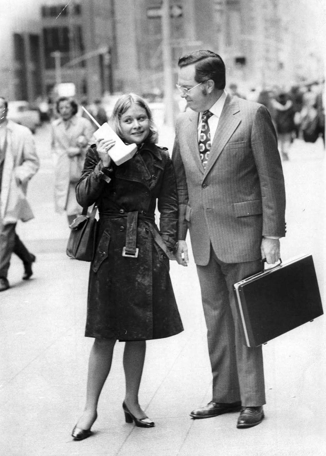 Jeanne Bauer a DynaTAC-vel sétál a New York-i 6. sugárúton, John Mitchell, a Motorola mérnök telefon kíséretében.  1973-tól.