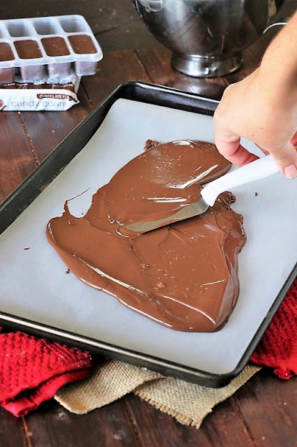 Spreading Chocolate with Offset Spatula to Make Chocolate Chip Cookie Dough Bark Image